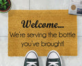 'We're Serving The Bottle You've Brought' Welcome Doormat